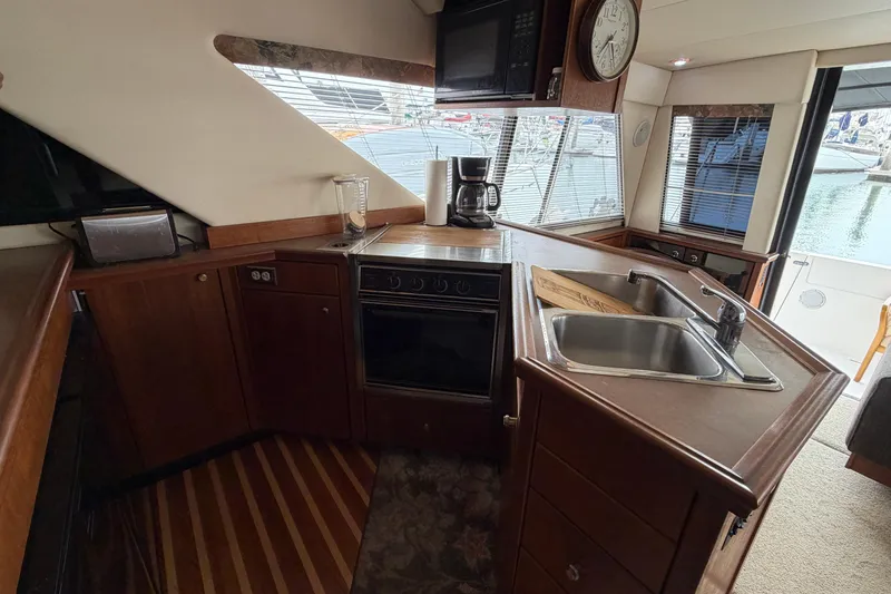 Slide: The Image of Interior of 1996 Bayliner 3988 Command Bridge Motoryacht kitchen with sink and appliances. - 30