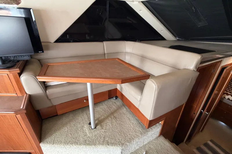 Slide: The Image of Interior of 1996 Bayliner 3988 Command Bridge Motoryacht with seating and table. - 32