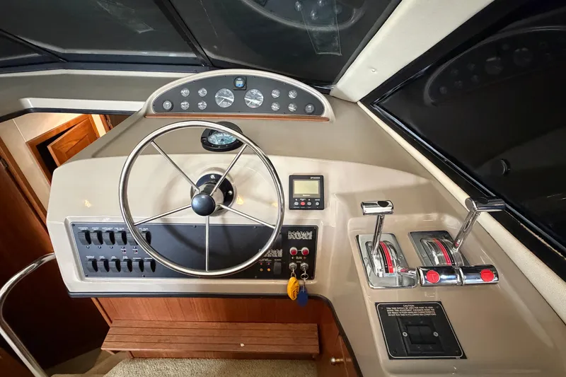 Slide: The Image of Helm of 1996 Bayliner 3988 Command Bridge Motoryacht with steering wheel and control panel. - 35