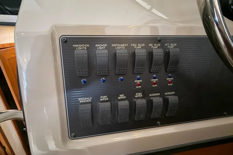 Slide: The Image of Control panel of a 1996 Bayliner 3988 Command Bridge Motoryacht with various switches. - 39