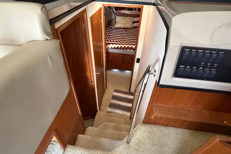 Slide: The Image of Interior view of 1996 Bayliner 3988 Command Bridge Motoryacht, featuring stairs and cozy cabin. - 40