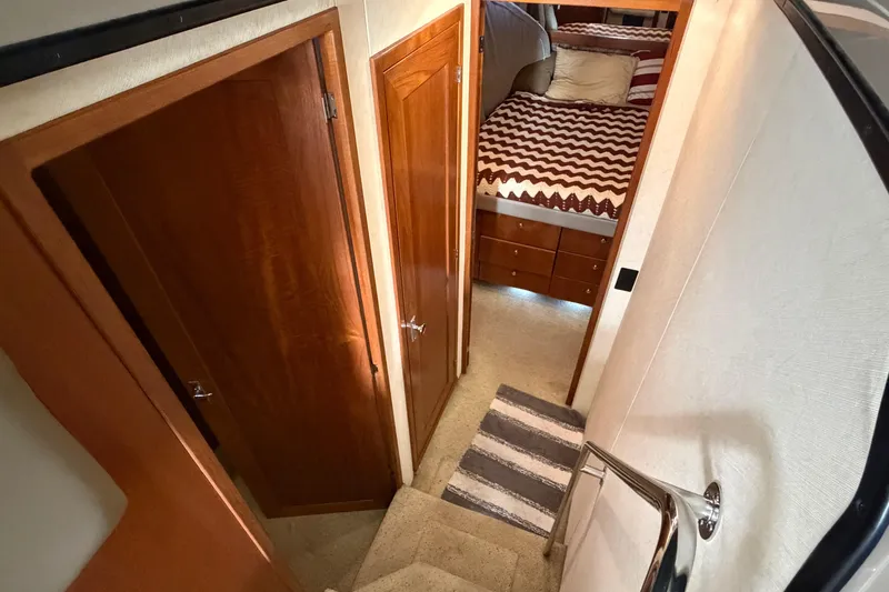 Slide: The Image of Interior of 1996 Bayliner 3988 Command Bridge Motoryacht with wooden doors and cozy bedroom. - 41