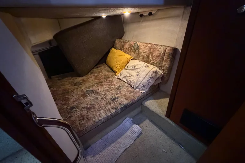 Slide: The Image of Cozy cabin interior of 1996 Bayliner 3988 Command Bridge Motoryacht with cushioned seating. - 42
