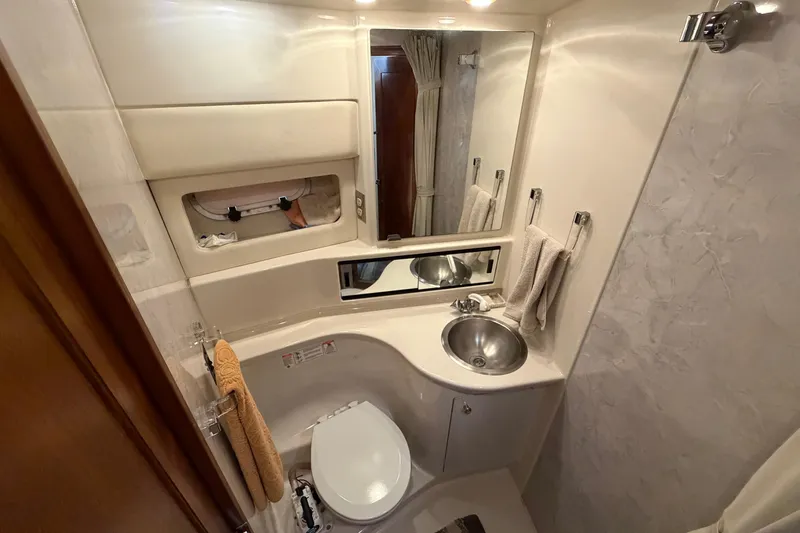 Slide: The Image of Bathroom interior of 1996 Bayliner 3988 Command Bridge Motoryacht, featuring sink and toilet. - 43