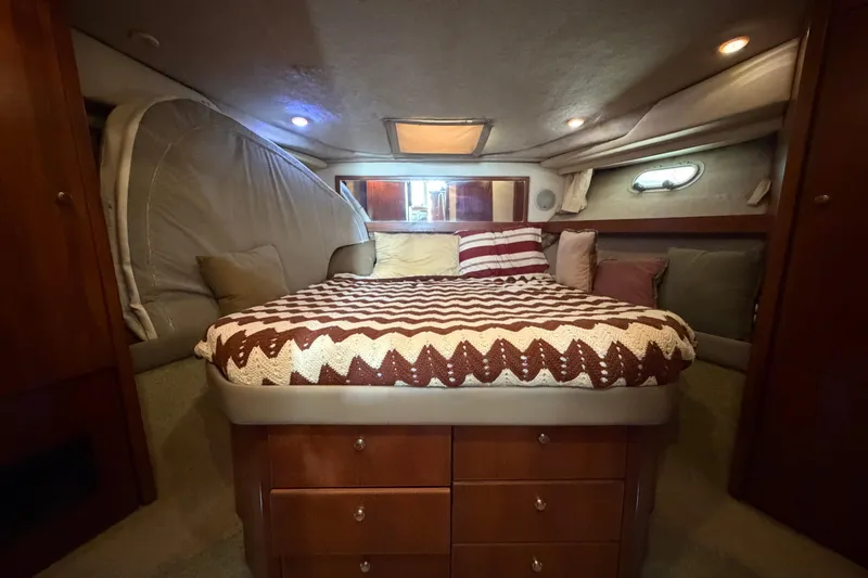 Slide: The Image of Cozy bedroom in 1996 Bayliner 3988 Command Bridge Motoryacht with patterned bedding and ambient lighting. - 45