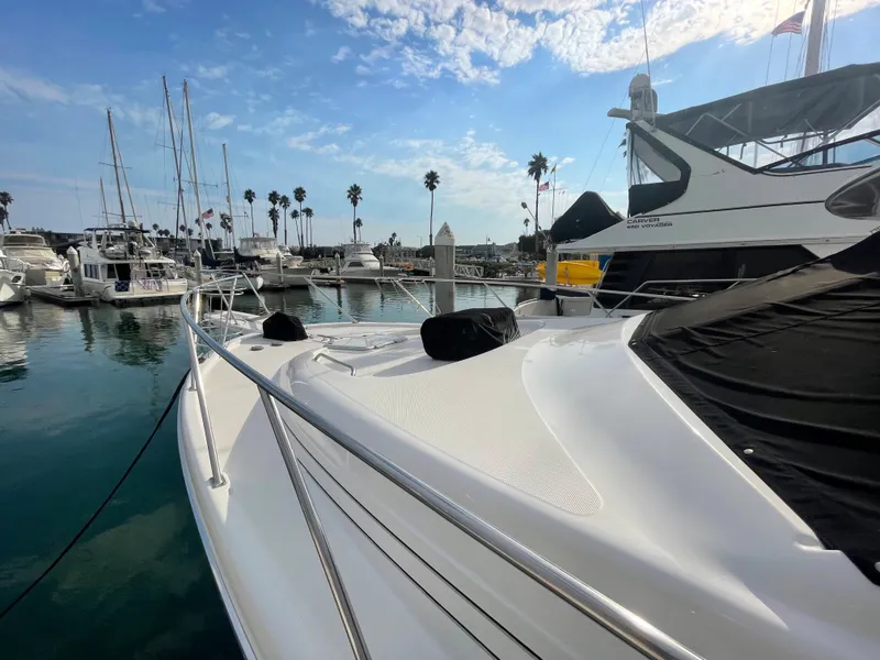 Slide: The Image of 1996 Bayliner 3988 Motoryacht docked with palm trees in background. - 7