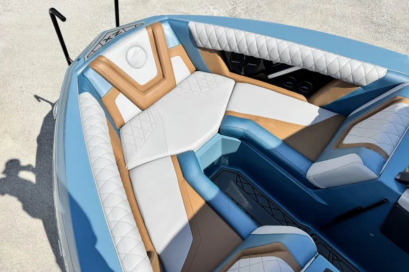 Slide: The Image of 2021 Tigé 23ZX boat interior with luxurious white and tan seating, blue accents. - 10