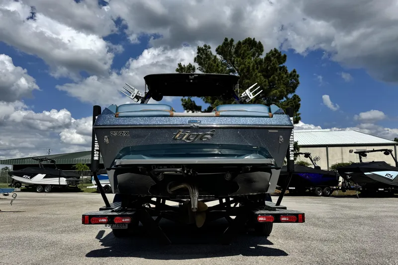 Slide: The Image of 2021 Tigé 23ZX boat on trailer under cloudy sky. - 5