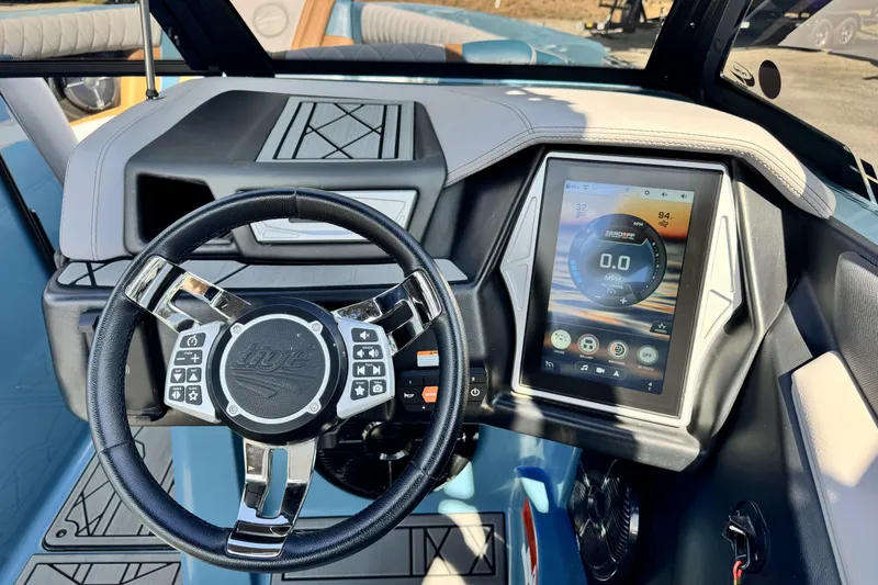 Slide: The Image of 2021 Tigé 23ZX boat dashboard with touchscreen display and multifunction steering wheel. - 8