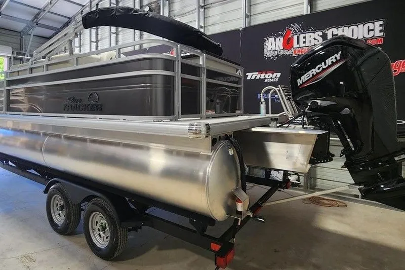Slide: The Image of 2026 Sun Tracker Fishin' Barge 20 DLX pontoon boat with Mercury engine in showroom. - 4