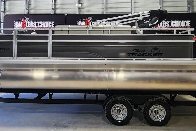 Slide: The Image of 2026 Sun Tracker Fishin' Barge 20 DLX pontoon boat on trailer in showroom. - 6