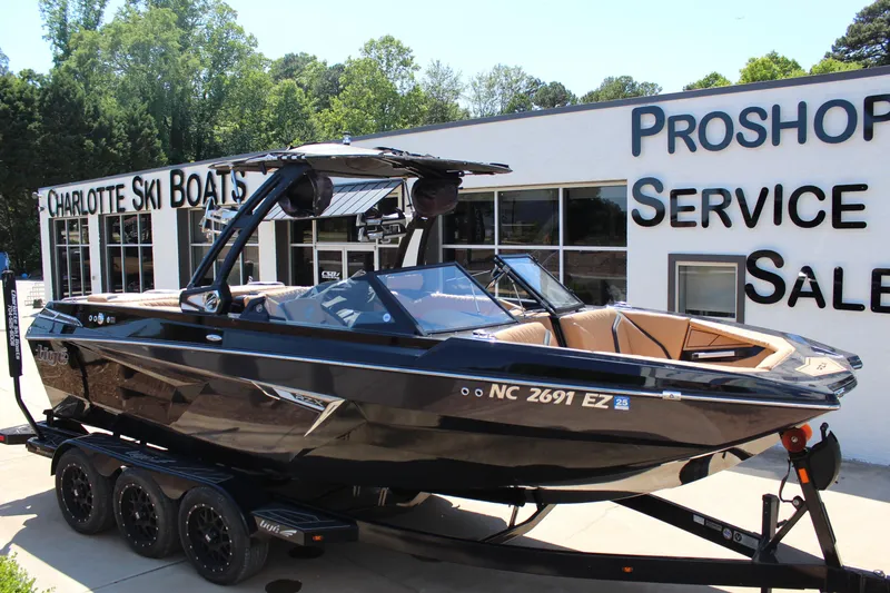 The Image of 2022 Tigé 22RZX boat on trailer outside Charlotte Ski Boats dealership. - 1