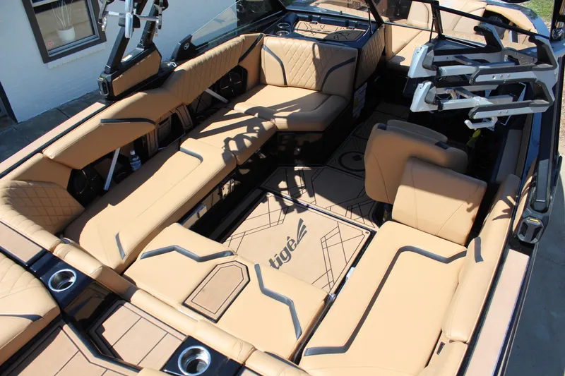 Slide: The Image of 2022 Tigé 22RZX boat interior with tan seating and modern design. - 11