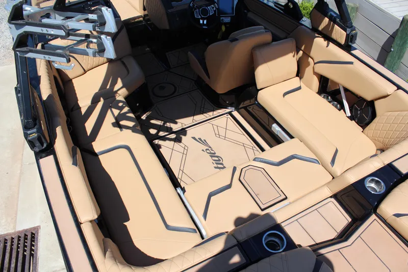 Slide: The Image of 2022 Tigé 22RZX boat interior with tan leather seating and modern design. - 12