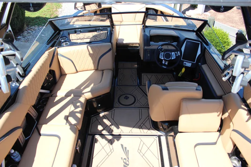 Slide: The Image of Interior of 2022 Tigé 22RZX boat with tan seating and modern dashboard. - 13