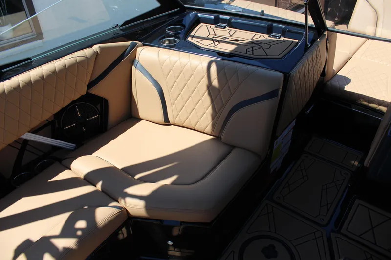Slide: The Image of 2022 Tigé 22RZX boat interior with beige diamond-stitched seating and modern design. - 14