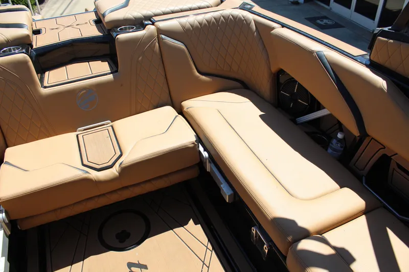 Slide: The Image of 2022 Tigé 22RZX boat interior with tan leather seating and stylish design. - 15