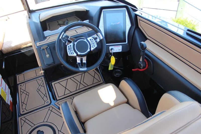 Slide: The Image of Interior of 2022 Tigé 22RZX boat featuring modern steering and touchscreen controls. - 17
