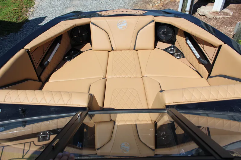 Slide: The Image of Luxurious interior of 2022 Tigé 22RZX boat with tan upholstery and cup holders. - 19