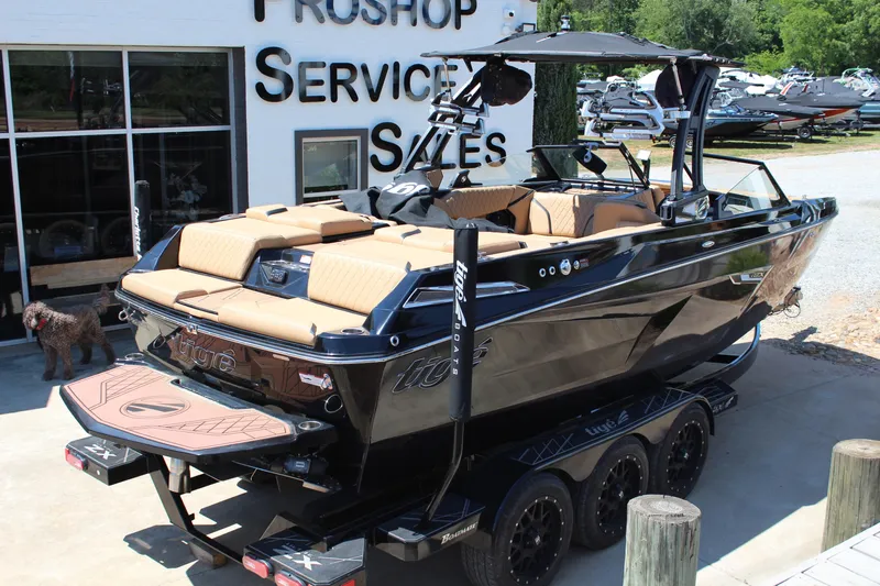 Slide: The Image of 2022 Tigé 22RZX boat at dealership, showcasing sleek design and luxurious interior. - 3