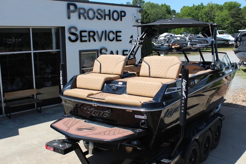 Slide: The Image of 2022 Tigé 22RZX boat at a pro shop, featuring luxurious seating and sleek design. - 4