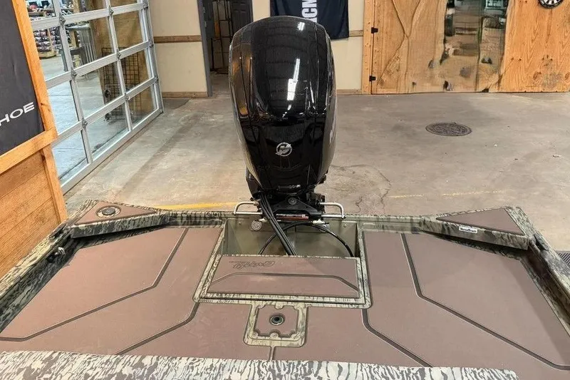 Slide: The Image of 2017 Tracker Pro Team 175 TXW boat with Mercury outboard motor in a garage setting. - 9