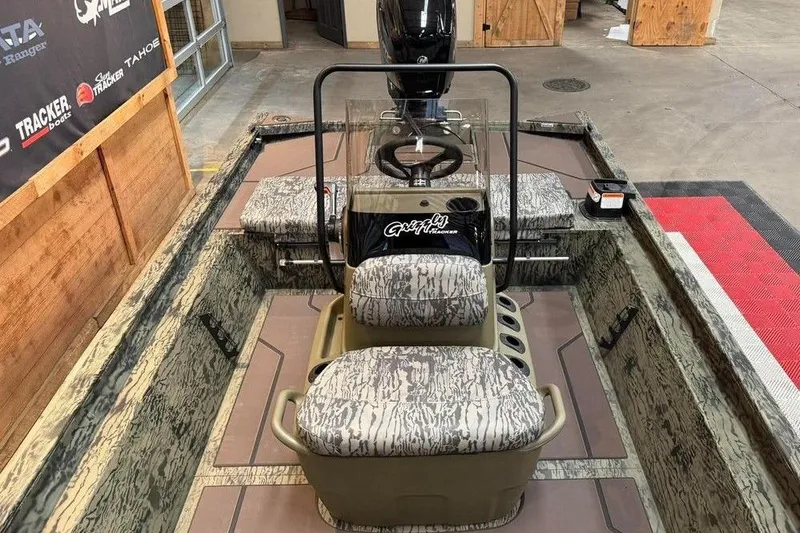Slide: The Image of 2017 Tracker Pro Team 175 TXW boat interior with camo seats and steering console. - 3