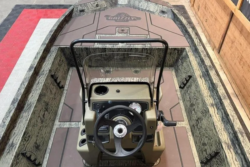 Slide: The Image of 2017 Tracker Pro Team 175 TXW boat interior with steering console and camouflage design. - 5