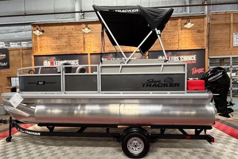 The Image of 2026 Sun Tracker Bass Buggy 16 XL Select pontoon boat with canopy and Mercury outboard motor. - 0