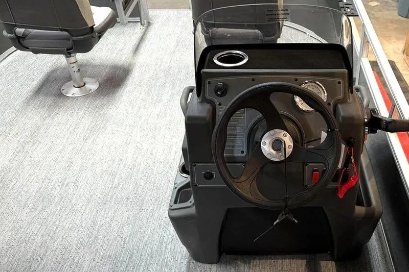 Slide: The Image of 2026 Sun Tracker Bass Buggy 16 XL Select steering console with modern controls and seating. - 3