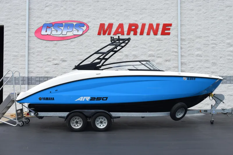 The Image of 2023 Yamaha AR250 boat in blue on trailer at GSPS Marine dealership. - 1