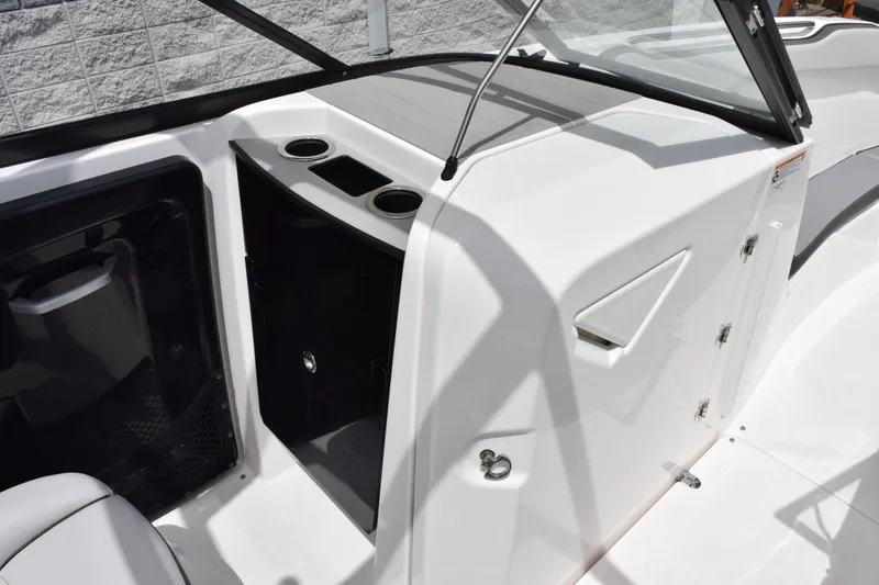 Slide: The Image of 2023 Yamaha Boats AR250 interior with cup holders and storage compartment. - 13