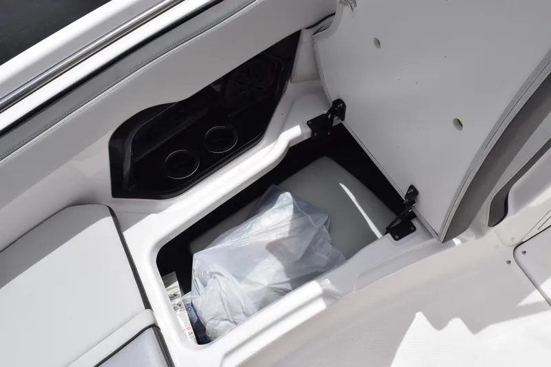 Slide: The Image of 2023 Yamaha AR250 boat storage compartment with cup holders and interior view. - 17