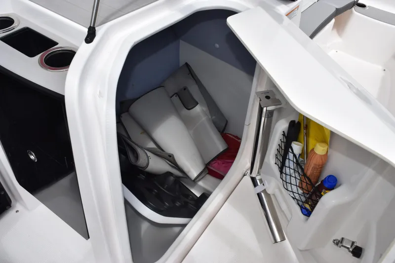 Slide: The Image of 2023 Yamaha AR250 boat storage compartment with accessories and supplies. - 19
