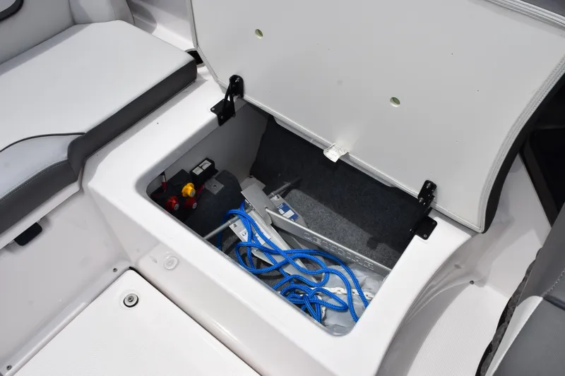 Slide: The Image of Open storage compartment in 2023 Yamaha AR250 boat with blue rope and accessories. - 21
