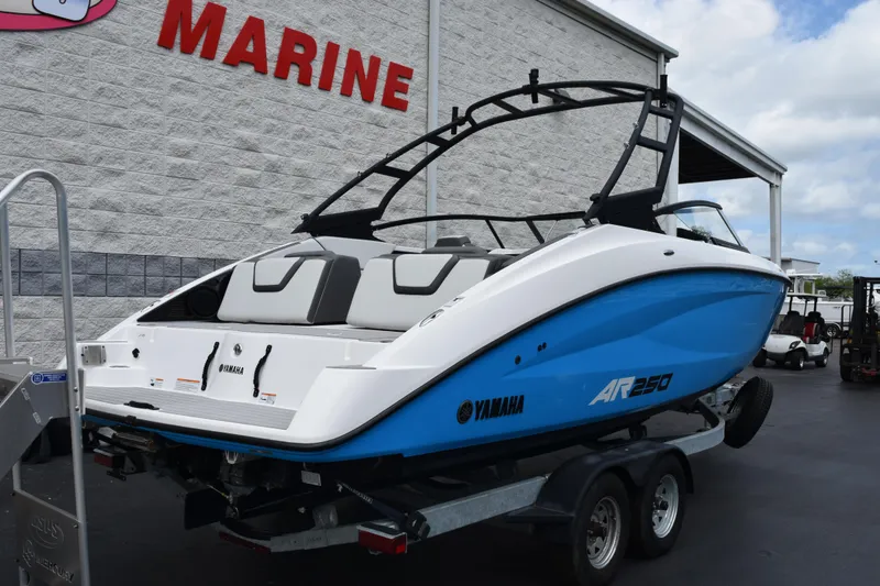 Slide: The Image of 2023 Yamaha AR250 boat on trailer outside marine dealership. - 4
