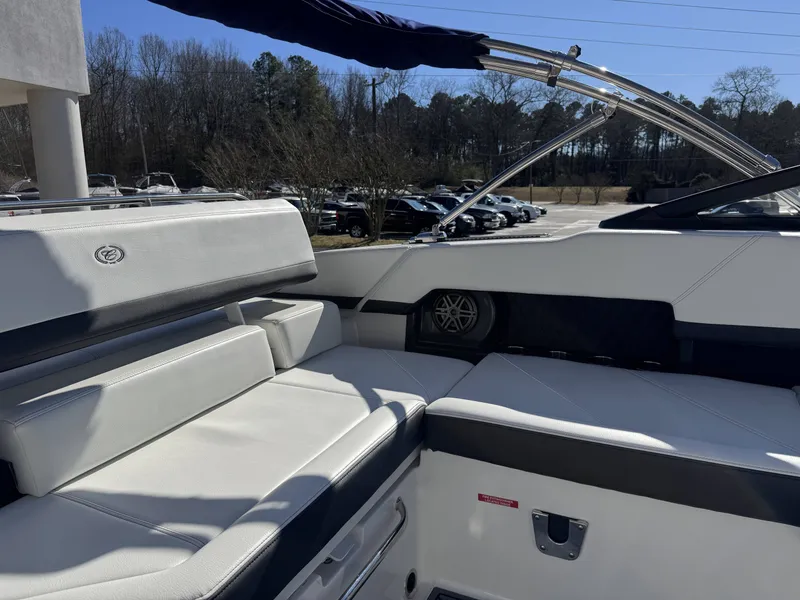 Slide: The Image of Interior of a 2026 Cobalt R4 boat with white leather seating. - 24