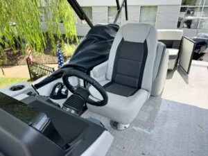 Slide: The Image of 2024 Harris CX 230 boat helm with modern seat and steering wheel. - 3