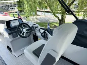 Slide: The Image of Interior of 2024 Harris CX 230 boat with steering wheel and seat. - 4