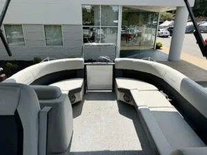 Slide: The Image of Interior of a 2024 Harris CX 230 pontoon boat with gray seating. - 5