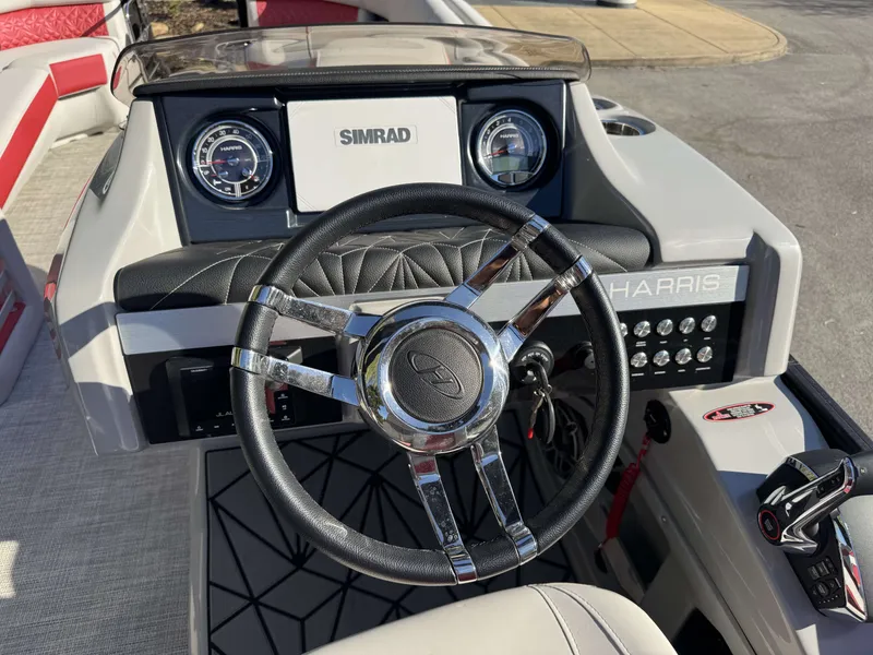 Slide: The Image of Steering wheel of 2024 Harris Grand Mariner 250 with Simrad display. - 12