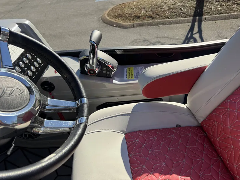 Slide: The Image of Interior of 2024 Harris Grand Mariner 250 with steering wheel and throttle. - 14