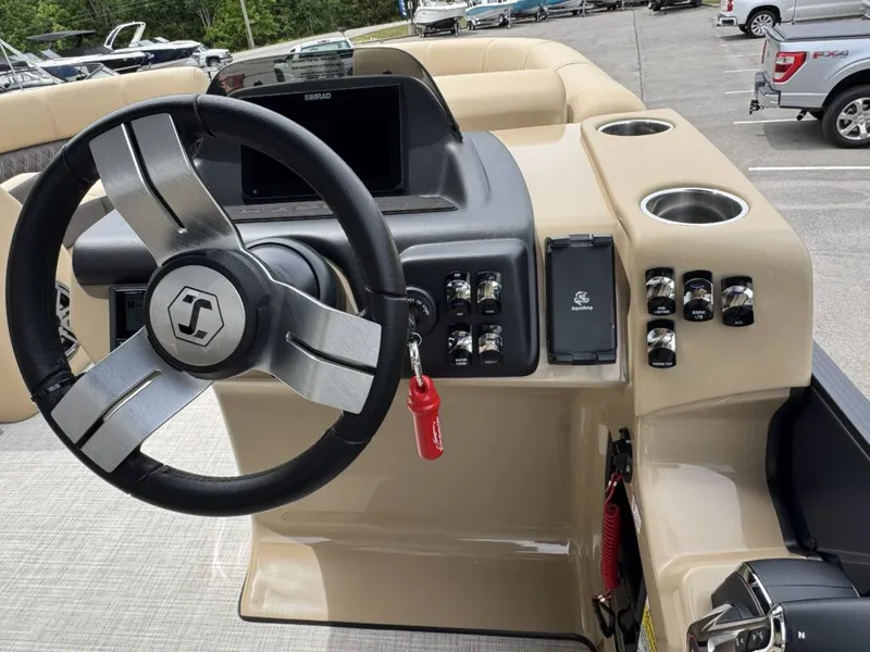 Slide: The Image of Steering wheel and dashboard of a 2025 Harris SUN 210 boat. - 11