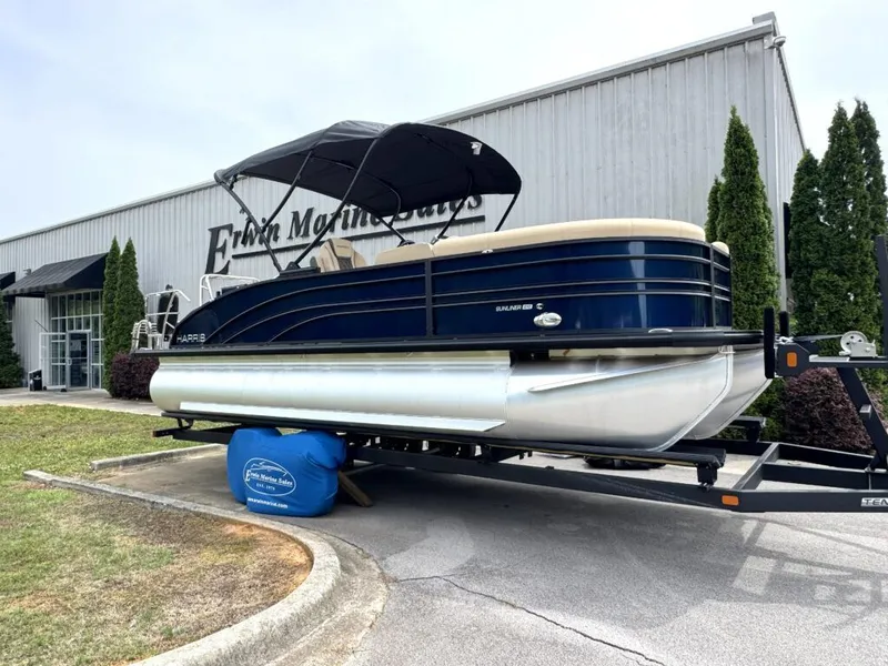 Slide: The Image of Harris SUN 210 pontoon boat 2025 parked outside a building. - 3