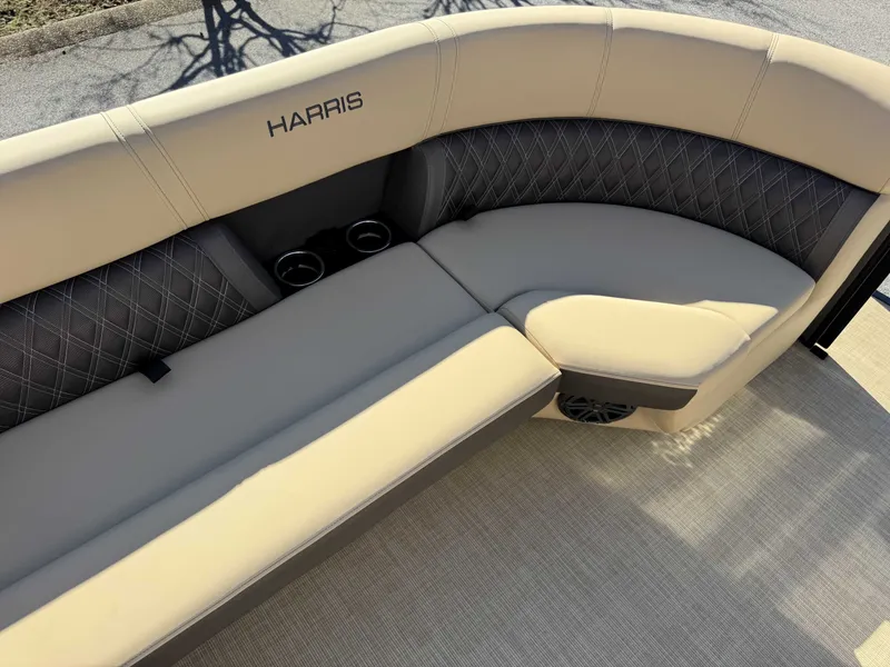 Slide: The Image of Harris SUN 250 2025 boat seat with beige upholstery and cup holders. - 25