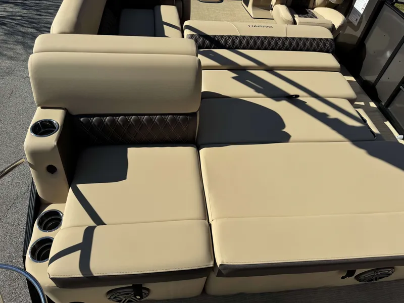 Slide: The Image of Harris SUN 250 2025 boat with beige upholstery and cup holders. - 6