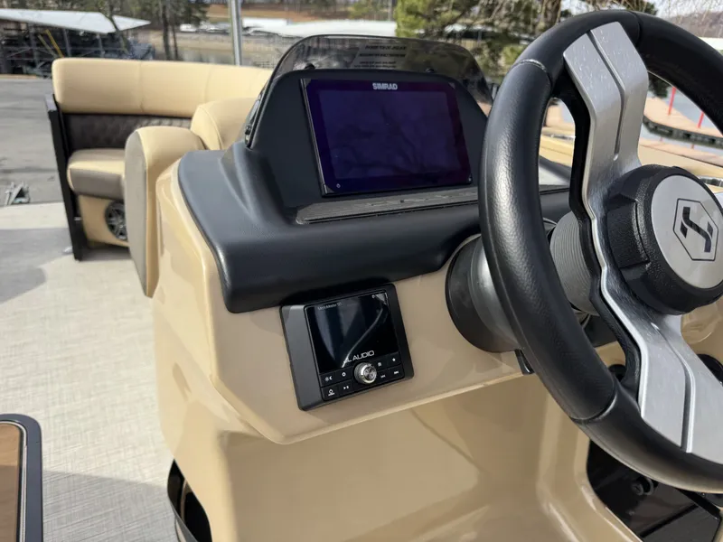 Slide: The Image of Interior view of Harris SUN 250 SPORT 2025 boat with steering wheel and control console. - 12