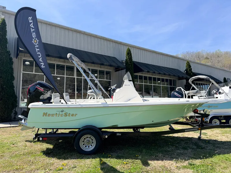 The Image of 2023 NauticStar 195 XTS boat displayed outside a building. - 1