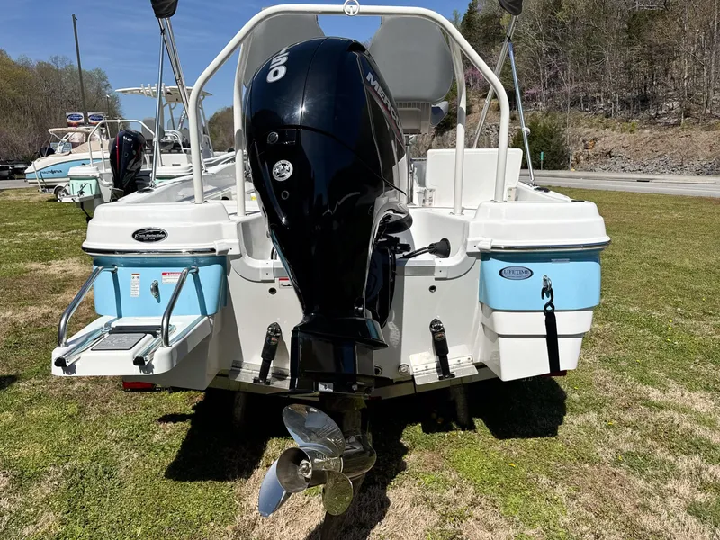 Slide: The Image of Rear view of a 2024 NauticStar 211 Hybrid boat with outboard motor. - 6