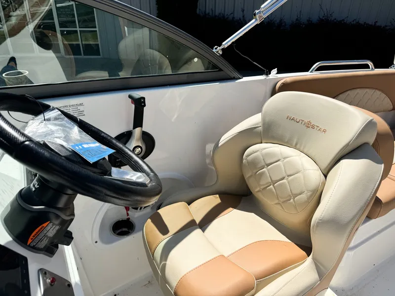 Slide: The Image of Interior of 2024 NauticStar 223 DC with steering wheel and seat. - 5